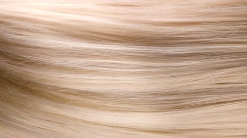 Hair. Beautiful healthy long straight blonde hair close-up texture. Dyed Wavy white blond hair background, coloring, extensions, cure, treatment concept. Haircare. Slow motion 4K UHD video