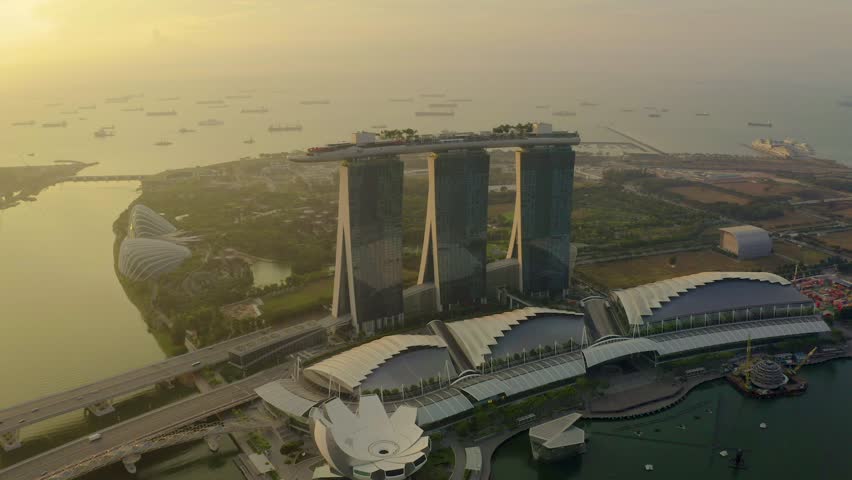 Drone Aerial view 4k Footage of the Marina Bay Sands in Singapore City Skyline. Sunrise Royalty-Free Stock Footage #1026628628