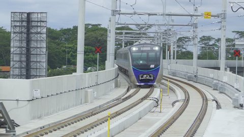 JAKARTA, Indonesia - March 26, 2019: Jakarta Mass Rapid Transit (MRT) train moving on the track and arriving at Fatmawati station in South Jakarta. Shot in 4k resolution
