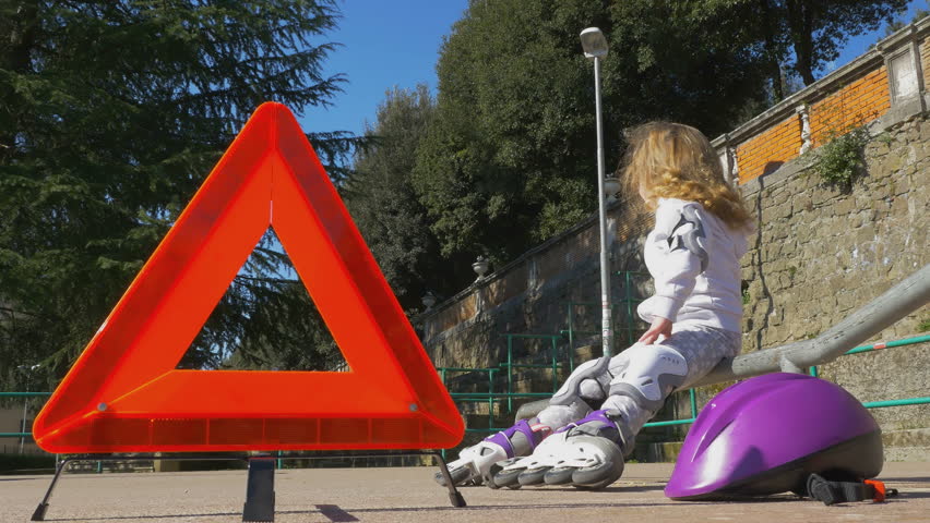 Cute girl is resting and eat snacks in the park on rollerblade, bottom view 4K footage, more options in my portfolio