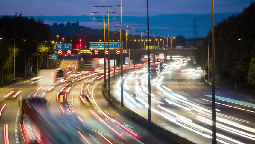 Car lights at rush hour on an motorway junction, traffic on London Orbital motorway M25, timelapse. Royalty-Free Stock Footage #1026637127