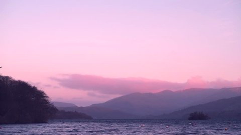 Very Calm Lake Windermere (Lake District, UK) during a clear pink early sunrise- March 2019
