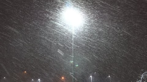 Markham, Ontario, Canada March 2019 Heavy pretty snow falling at night in near blizzard conditions in the city