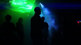 Laser show party. Silhouettes of people dancing in a disco