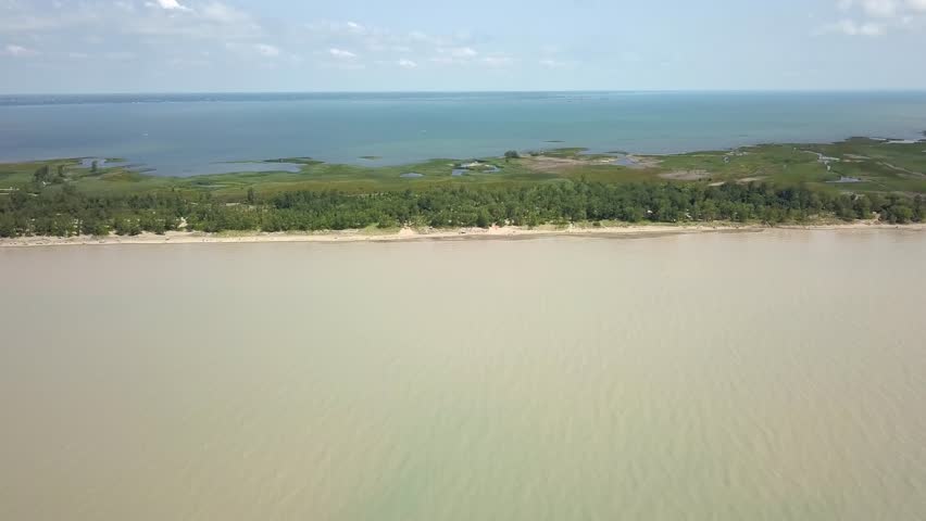 Lake Erie, beach and turbid water after storm. Aerial view. 4k