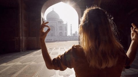 Young woman practicing yoga in India at the famous Taj Mahal at sunrise - People travel spirituality zen like concept- Girl doing yoga poses in sacred place 