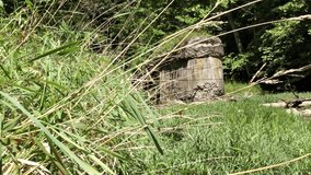 Slider Shot of Old Collapsed Bridge Pylon in Middle of Forest RIver - Powered by Shutterstock - Get 15% off with code: PIKWIZARD15