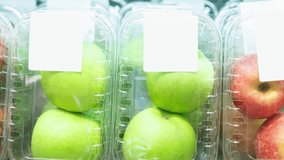 Footage of fresh green and red apples in containers at the food aisle in supermarket.Buy natural ingredients for healthy eating.