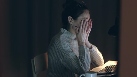 Beautiful Woman takes off his glasses and rubbing tired eyes. Female yawn and want to sleep. Problem with glasses, eyesight or vision. Working late with computer. Astigmatism, myopia or insomnia.