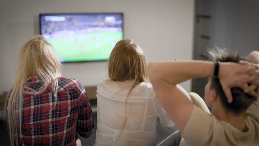Young man and woman watching TV | Shutterstock HD Video #1026702266