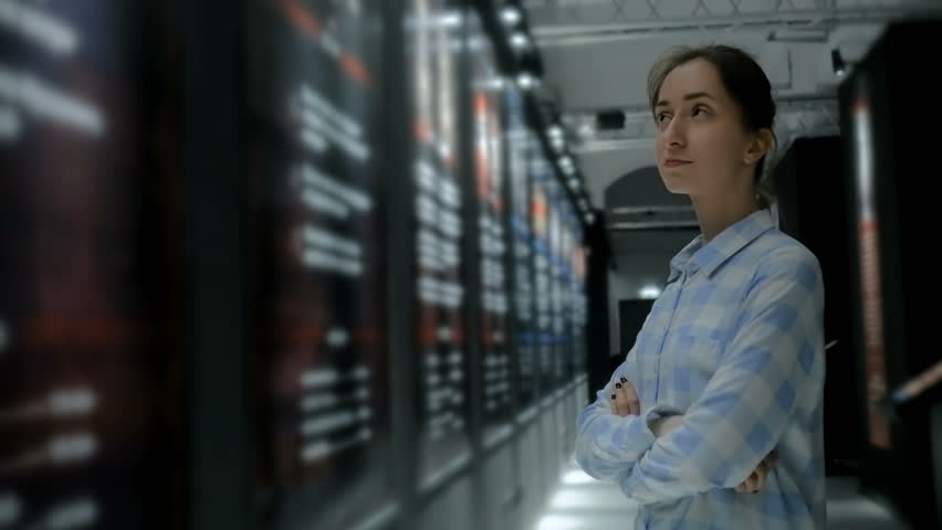 Young woman looking around in modern historical museum. Evening time, low light illumination. Education, learning and entertainment concept