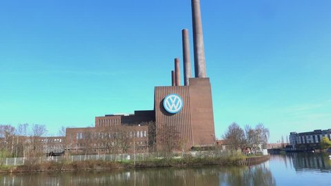 Wolfsburg, Germany, March 30., 2019: View of the power plant of the Volkswagen plant with the large VW logo on the side of the brick building, zoom in on the logo.
