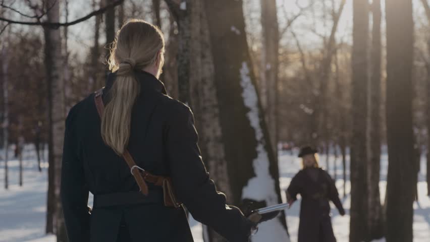 The fight between two men of the 19th-century. Duel on pistols in forest in winter
