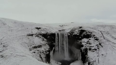 Aerial view of Skogafoss waterfall in Iceland. Cloudy winter day.