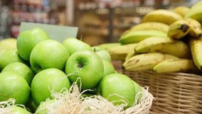 Footage of basket with fresh ripe green apple fruits on sale in grocery food store.Supermarket shop,natural foods department.Close up video,focus on apples in box