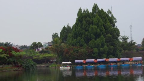 Bandung, Indonesia - March 25 2019: Floating market lembang west java a long boat was driving around the lake and carrying local tourists in the afternoon