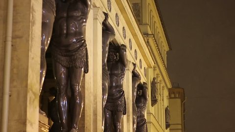 SAINT PETERSBURG, RUSSIA, DECEMBER 13, 2017: The building of the New Hermitage with statues of Atlantis at night in winter. Hermitage is one of the largest museums in the world.