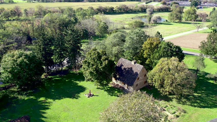 Aerial pan from Herr House, a historical landmark, across property and roadway to Longhouse replica. Concept: National Park Service, Historic Places, Mennonite, colonial America, Amish, landmark