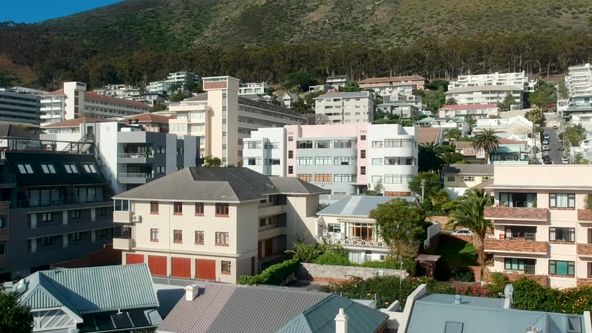 A drone shot hovering above houses on the slopes of Signal Hill in Cape Town, South Africa.