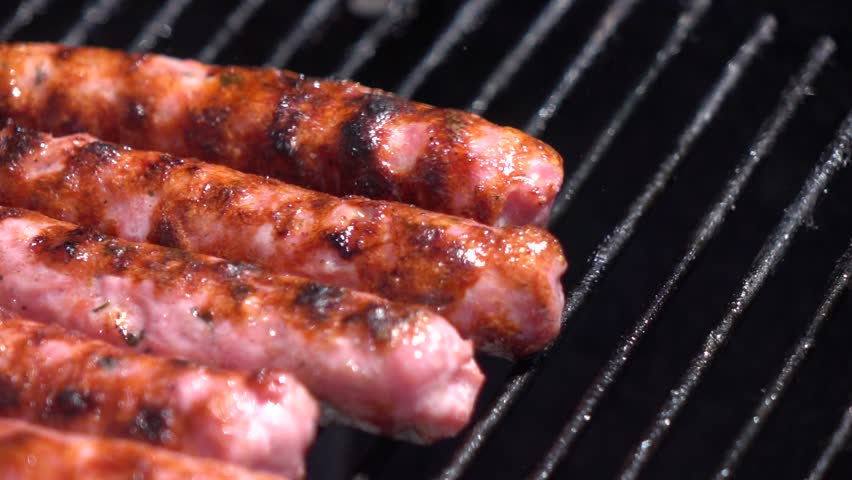 Slow Motion Close Up of Sausages Being Grilled On a Barbecue (250FPS)