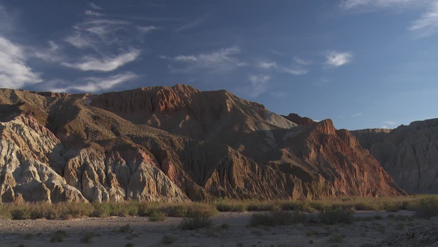 Pan of colorful cliffs in Afton Canyon in evening.