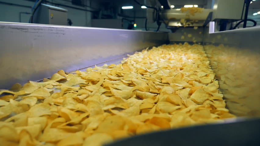 Factory conveyor moving fried chips after sorting, slow motion. Royalty-Free Stock Footage #1026739865