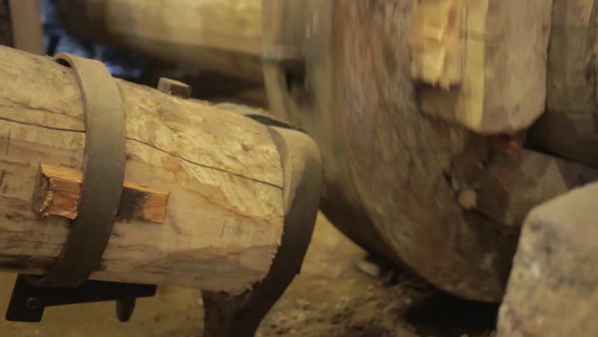 Wooden gear wheel powering antique power hammer.