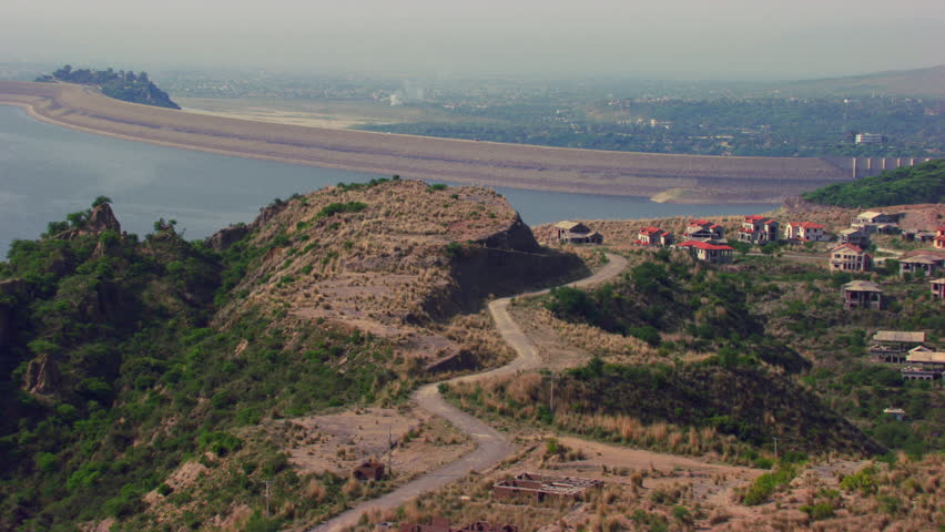 An Ireland Aerial view with hill top, Showing houses and forest with highway over the river, Huge view of city in the background