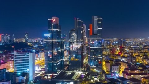 Business and finance area of Istanbul with highrises and shopping malls and commercial buildings at night. Istanbul, Turkey - Mart, 2019. Aerial drone Timelapse 4K