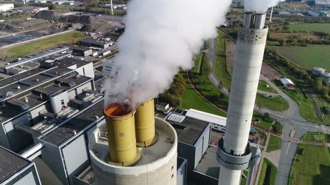 Aerial bird view of coal fired power plant thermal station flues this electricity production provides about 32 percent of consumed electricity in the United States showing thick white flue exhaust 4k
