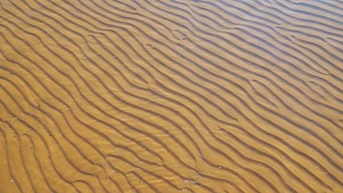 Transparent seabed. Sand and salt of the dead sea. Ripples on the surface of the water.