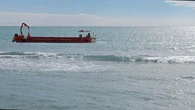 Glitch effect. Red barge in the sea. Ostia, Italy