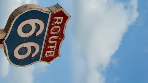 Vertical Video. Time Lapse of Route 66 sign and blue sky