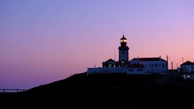 Wide angle video of Cabo da Roca Lighthouse over the cliffs at dusk, Portugal. The most westerly point of the European mainland.