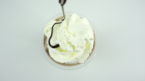 Cocoa in cup topped whip cream chocolate on white background.