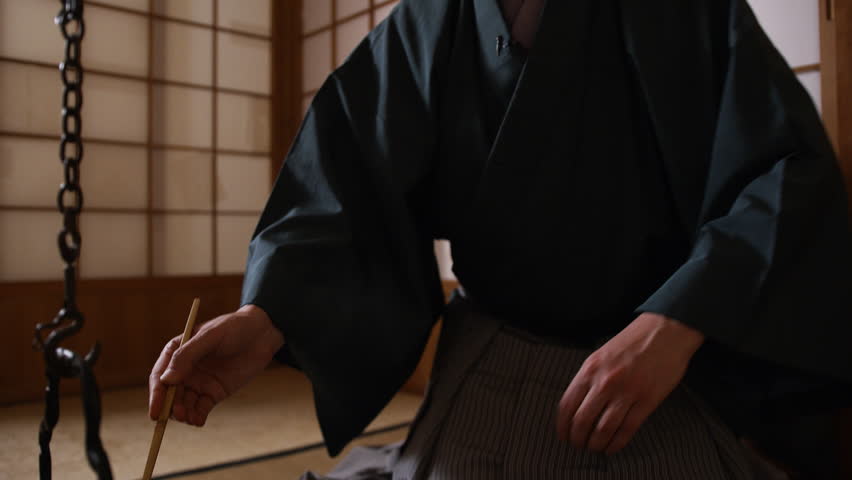 Japanese tea ceremony, the Way of Tea. Tea master pours water into a cup (chawan) Royalty-Free Stock Footage #1026781796