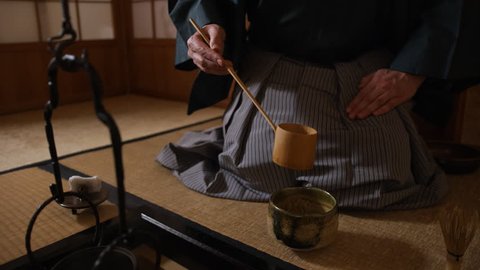 Japanese tea ceremony, the Way of Tea. Tea master pours water into a cup (chawan)