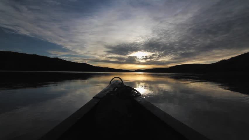 Yukon River, Yukon Territories, Canada. Sunset view from moving canoe.