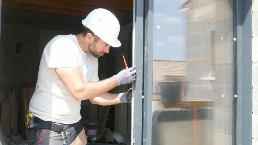 Handsome young man installing bay window in a new house construction site
 | Shutterstock HD Video #1026787448