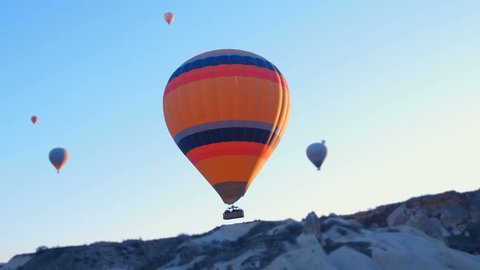 hot-air balloons flying over the mountain landsape of Cappadocia,Turkey.