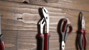 A close-up video of a carpenter putting a tool on its place. Equipment for craftsman. Hand tools set