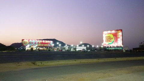 Delhi, India - Circa 2019: Panning shot of hills around the midway at jaipur delhi highway at dusk. The food restaurant resort is a popular stopover on the long drive from delhi to Rajasthan