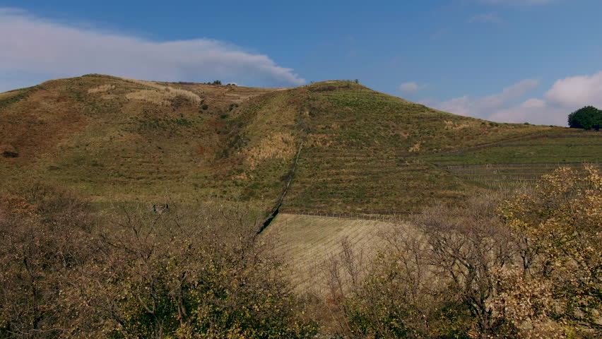 Aerial ascending view of a small crater revealing Mount Etna in Sicily (Italy)