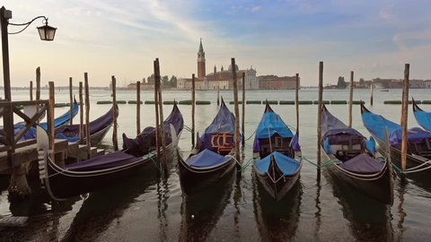 Traditional Gondolas on Canal Grande with San Giorgio Maggiore church in the background at morning, San Marco, Venice, Italy, 4k