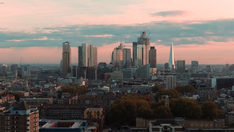 Aerial dolly view of the skyline of the city and central London from the North at sunset
