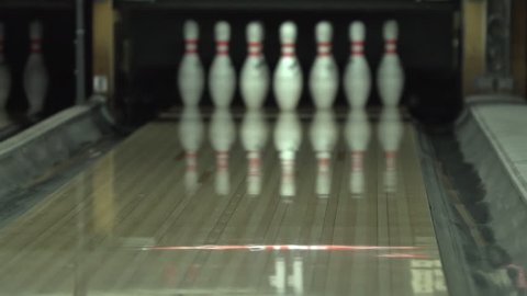 Slow motion shot of a bowling game. Bowling background. Strike. Close-up. Blurred background. Bowling alley