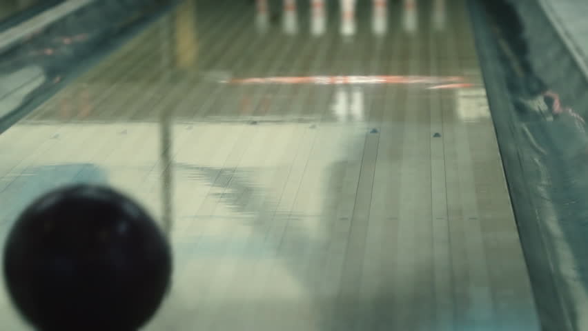 Slow motion shot of a bowling game. Bowling background. Bowling ball. Close-up. Bowling alley