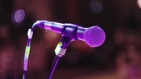 Close-up of classic microphone on stage on a dark blurred background