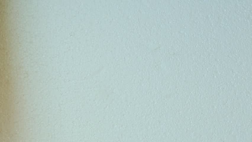 woman hand puts deep bowl with oatmeal and banana on white kitchen table