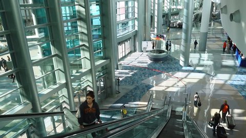 Anaheim, CA / USA - March 30, 2019: Person going up escalator inside the Anaheim Convention Center